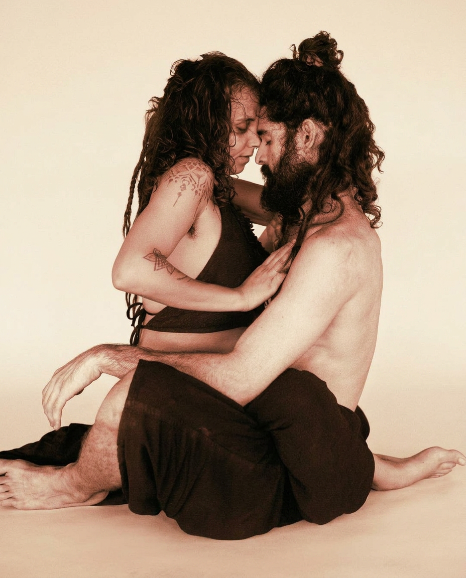 A couple sitting in close embrace, foreheads touching